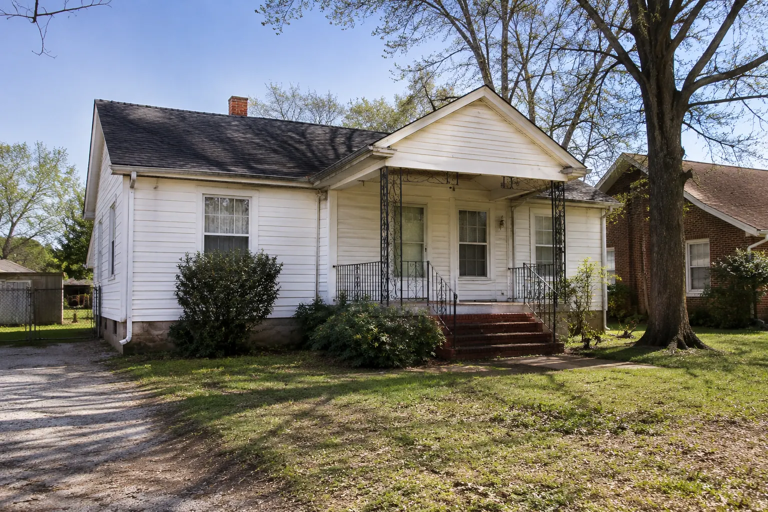 Affordable single-family home in East Texas with a spacious front yard, mature trees, and a quiet residential neighborhood.