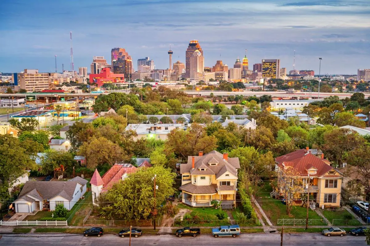 Residential homes in San Antonio with city skyline view representing urban and suburban real estate market in Texas